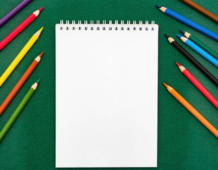 Top view of blank notebook and coloured pencils. Back to school conceptの写真素材