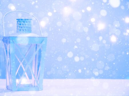 Winter background with lantern lamp, snowfall and copy space. Merry Christmas and Happy New Year!の写真素材