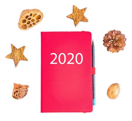 Top view of Christmas background with notepad, pencil and christmas decorations. 2020 planner