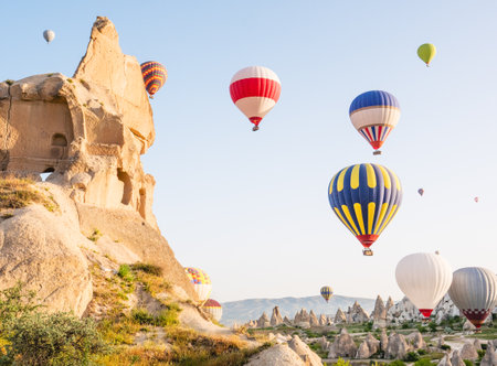 Colorful hot air balloons flying over rock landscape at Cappadocia Turkeyの写真素材