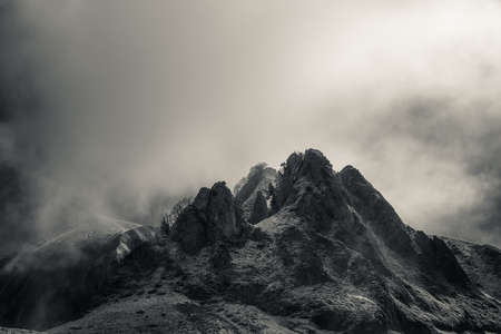 Mysterious black mountain with dramatic cloudy sky
