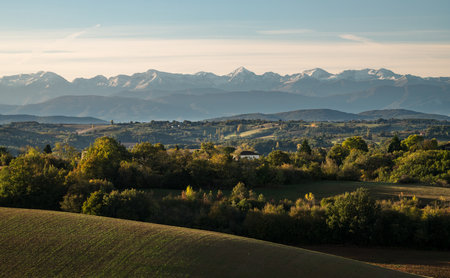 Countryside landscape in the Gers department in France with the Pyrenees mountains in the backgroundの写真素材