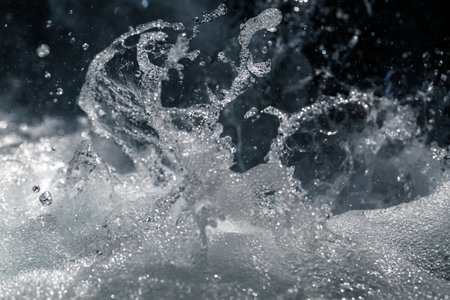 Water splash close-up of turbulent waters of a small mountain stream with shallow depth of fieldの写真素材