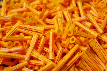 Orange plastic dowels as the background image.の写真素材