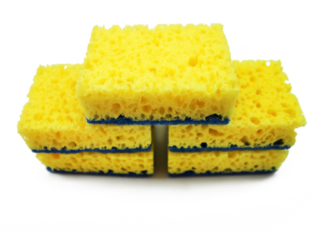 Yellow sponge for washing dishes isolated on white background.の写真素材