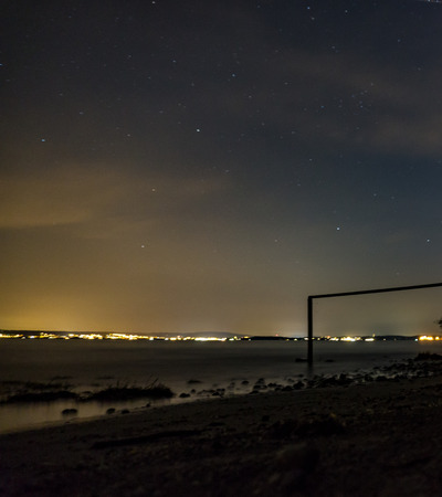 Stars in the night sky of Lake Constance. Wonderful lights and colors. Great view of the city lights.の写真素材