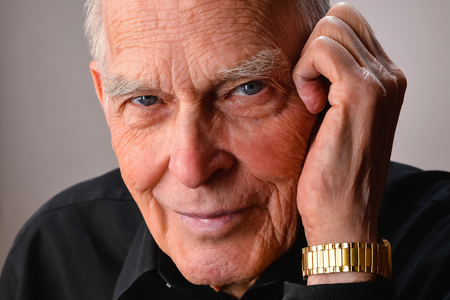 Close-up portrait of senior man with blue piercing eyesの写真素材