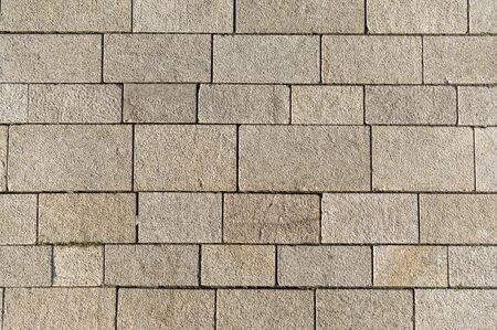 Market square with differently sized concrete blocks and joints as background