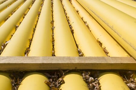 Natural gas pipes and gas pipelines are stacked at a construction site covered with fallen leaves