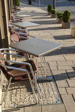 Empty and closed street cafe and almost deserted streets during the Corona Covid-19 pandemic in March 2020 in Germany in the city of Schweinfurtの写真素材