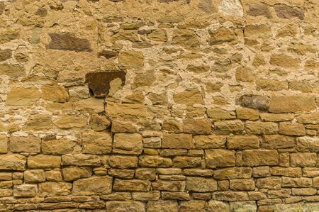 Bright sandstone wall with dark stone at the top not grouted downの写真素材