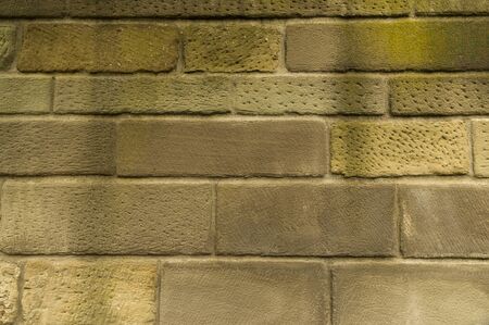 Natural stone sandstone wall with stones of different sizes brightly clean