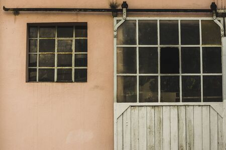 Facade of an old building with metal windows and rungs Goal bar rolling gateの写真素材