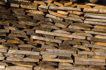 Wood stack of neatly stacked firewood and boards for drying firewood, firewood, raw material, wood rentalの写真素材