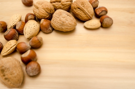 Various kinds of nuts, over wooden background