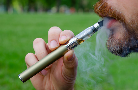 Close-up of a man vaping an electronic cigaretteの写真素材