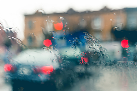 Blurred picture of traffic through a car windscreen during heavy rain.の写真素材