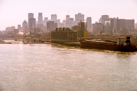 Montreal skyline from Jacques Cartier Bridge, with warm backlight, during golden hour.の写真素材