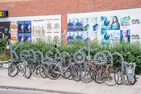 Toronto, Canada - 2 July 2016: Bike racks and Kensington neighbourhood metal sign in Toronto, Canada.のeditorial素材