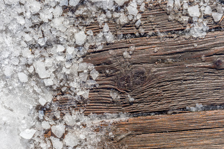 Pieces of shattered ice on a wood surfaceの写真素材