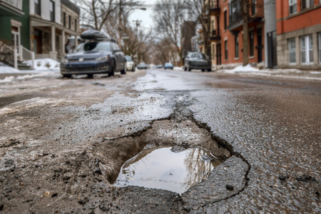 Large deep pothole in Montreal street, Canada.の写真素材