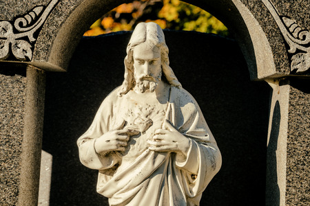 Christ Statue with head down in a cemeteryの写真素材