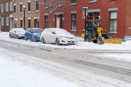 Montreal, CA - 17 December 2016: A snowplow in motion during snow storm.