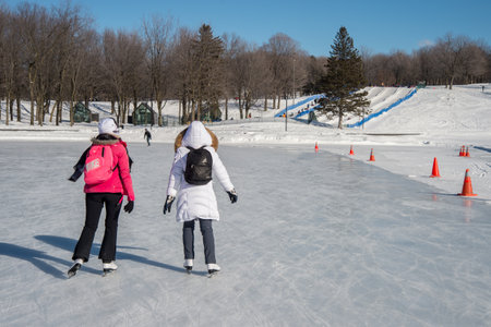 Montreal, CA - 31 January 2017: people skating on Beaver Lake skating rink on Mount-Royal
