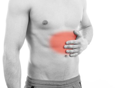 Yougn Man with stomach pain over white backgroundの写真素材