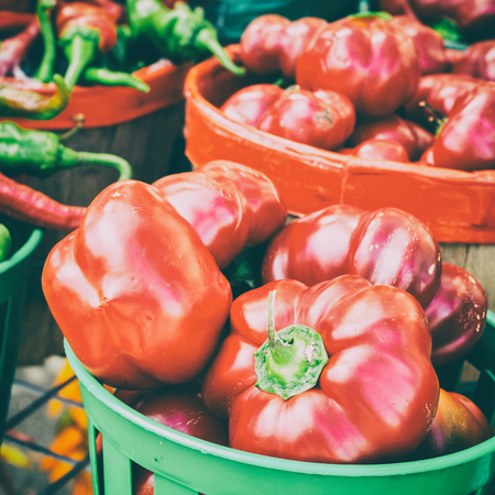 Romanian Gogosari and Carmer Peppers in a basket at the market with vintage effectの写真素材