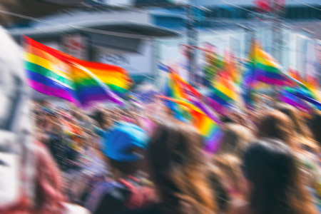 Motion blurred picture of a gay rainbow flag during pride parade. Concept of LGBT rights.の写真素材