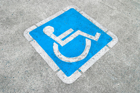 Blue disabled parking sign painted on dark asphalt in Canada in Ucluelet, Canadaの写真素材