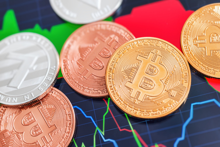 Cryptocurrency Bitcoin and Litecoin coins over tablet screenの写真素材