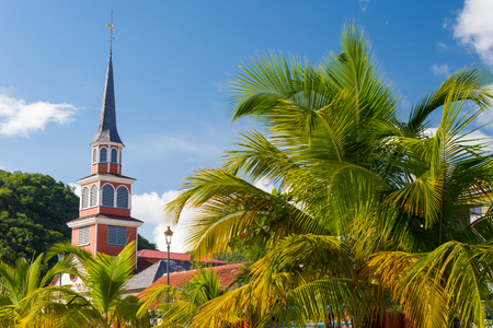 Petite Anse d'Arlet village in Martinique, with Saint Henri Church and palm treesの写真素材