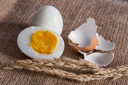 Sliced hard boiled eggs on burlap fabricの写真素材