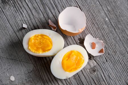 Sliced hard boiled eggs on wooden cutting board