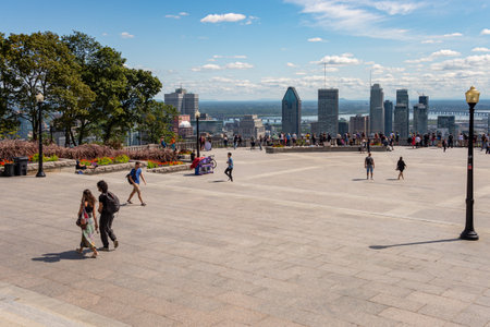 Montreal, CA - 3 September 2019: Tourists enjoying view of Montreal skyline from Kondiaronk Belvedere in summer.のeditorial素材