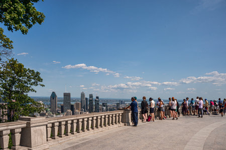 Montreal, CA - 1 August 2019: Tourists enjoying view of Montreal skyline from Kondiaronk Belvedere in summer at sunset.のeditorial素材