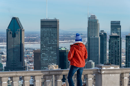 Montreal, Canada - 22 January 2019: Woman looking at Montreal Skyline from Kondiaronk belvedere.のeditorial素材