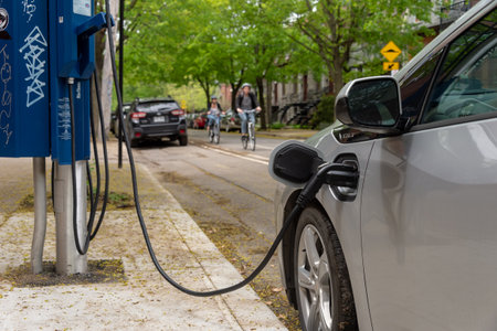 Montreal, CA - 25 May 2019: Chevrolet Volt electric car plugged into an EV charging station.のeditorial素材