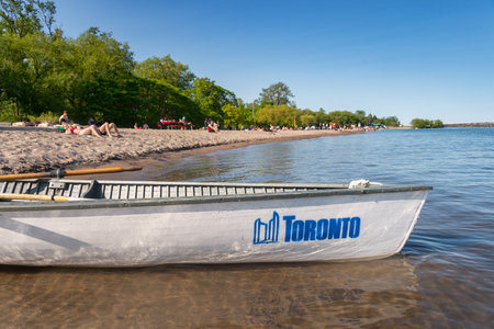 Toronto, CA - 23 June 2019: Small boat with Toronto city logo mooring at the Centre island beach.のeditorial素材