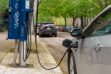 Montreal, CA - 25 May 2019: Chevrolet Volt electric car plugged into an EV charging station.のeditorial素材