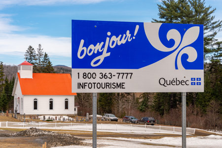 Hereford, QC, Canada - 21 April 2019: Welcome in Quebec sign at US/Canada border, with All Saints Anglican Church in backgroundのeditorial素材
