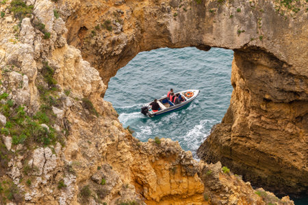 Lagos, Portugal - 4 March 2020: Tourists visiting Ponta da Piedade on a boatのeditorial素材