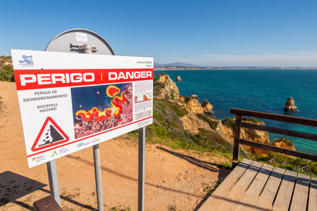 Lagos, Portugal - 7 March 2020: Rockfall hazard danger sign at Praia do Camilo beachのeditorial素材