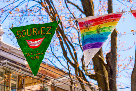 Montreal, CA - 13 May 2020: Souriez, Ca va bien aller (smile, Its going to be ok) message and rainbow drawing on pennants near Laurier Street. Montreal, CA - 13 May 2020: Souriez, Ca va bien aller (smile, Its going to be ok) message and rainbow drawing on pennants near Laurier Street.