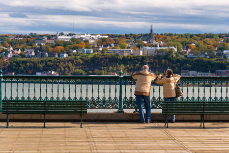 Quebec City, Canada - 4 October 2019: Couple on pedestrian walkway near Chateau Frontenac looking at...