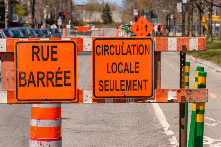 Montreal, Canada - 13 May 2020: Construction site on Mentana Street. Signs meaning Rue Barree &...
