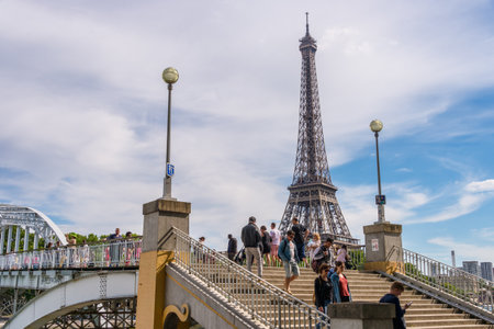 Paris, France - 23 June 2018: People walking on Debilly Footbridge with Eiffel Tower in the background.のeditorial素材