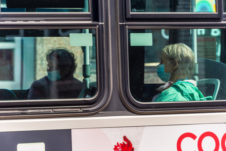 Montreal, CA - 17 May 2020: STM Bus passengers with face masks during Covid 19 pandemicのeditorial素材